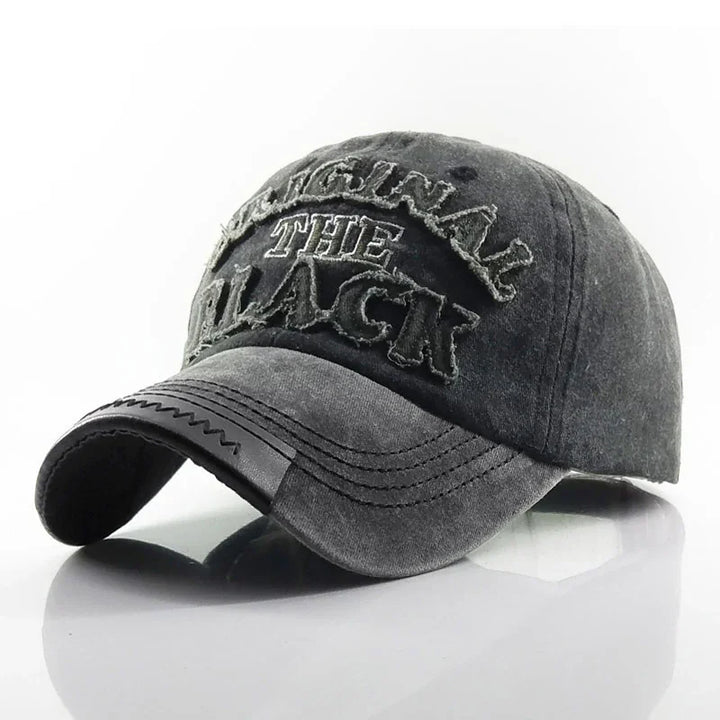 Grey distressed baseball cap with frayed embroidered letters spelling "ORIGINAL THE BLACK" on front