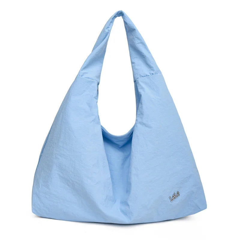 Light blue soft fabric hobo bag with wide handles and small embroidered logo