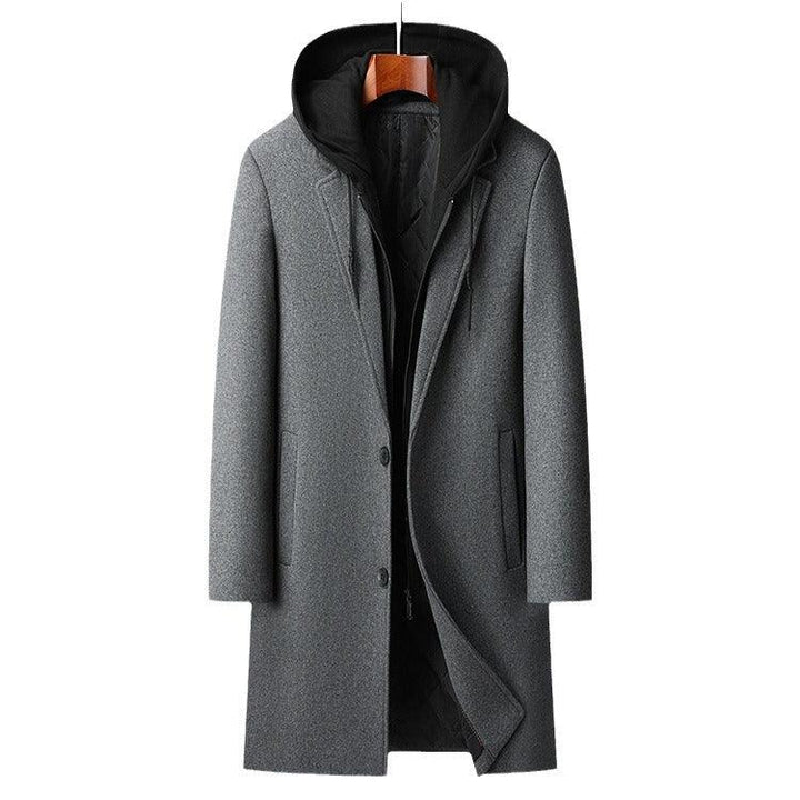 Men's gray wool overcoat with attached black hoodie, button closure, and side pockets on hanger