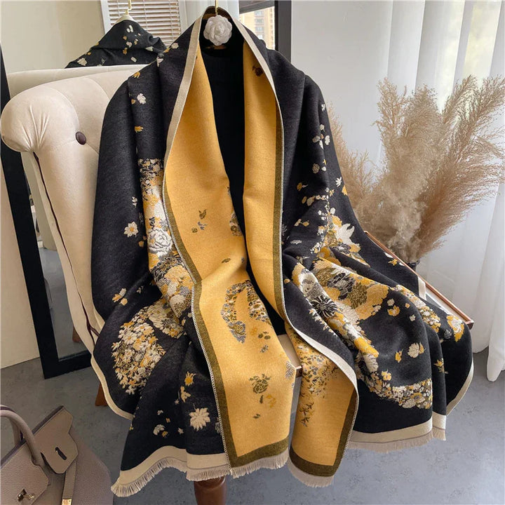 Elegant black and mustard floral patterned shawl draped over beige armchair in bright room