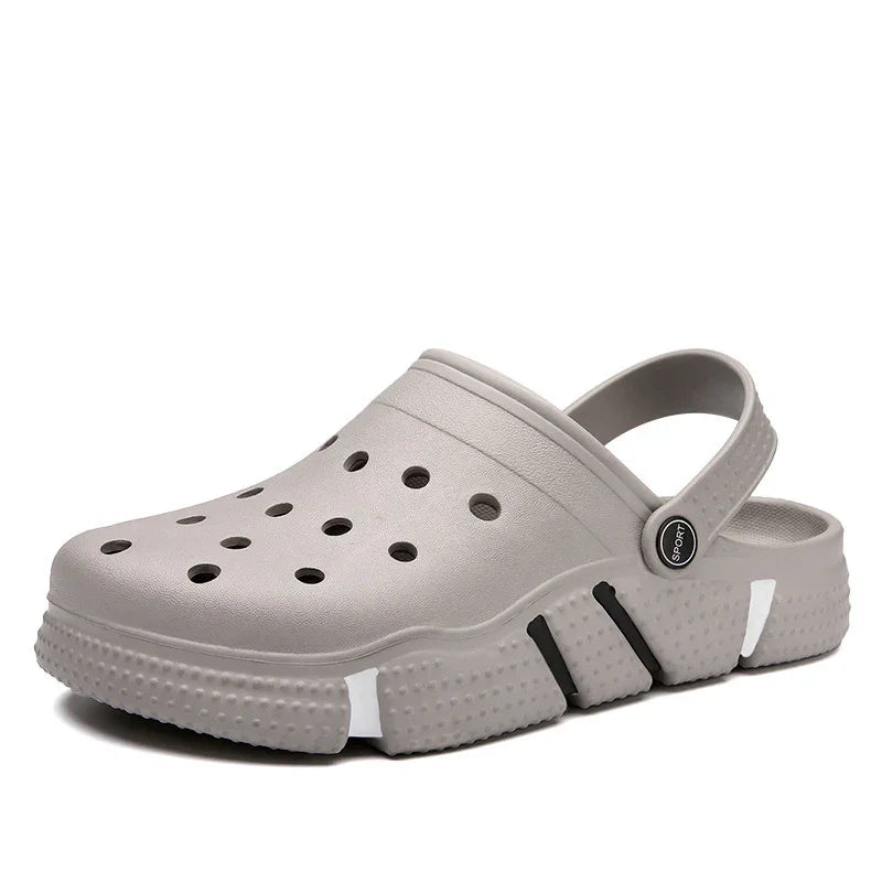 Gray sport clog with ventilation holes and adjustable heel strap on white background