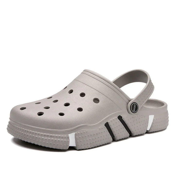 Gray sport clog with ventilation holes and adjustable heel strap on white background