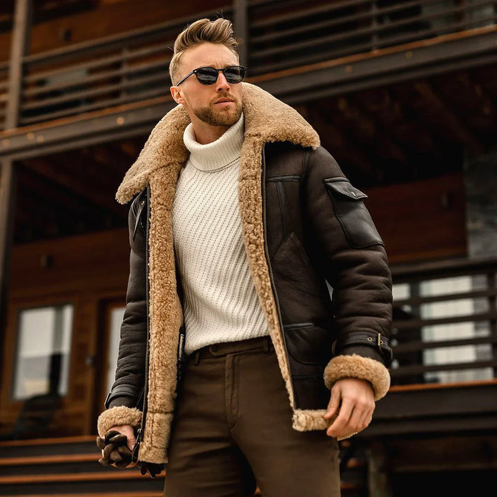 Stylish man wearing sunglasses, white turtleneck sweater, and brown shearling leather jacket outdoors