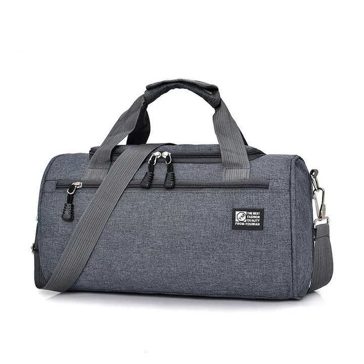Gray fabric duffel gym bag with handles, adjustable shoulder strap, and front zip pocket