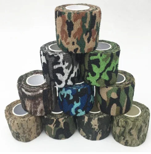 assorted camouflage self-adhesive wrap tapes stacked in a pyramid on a white background