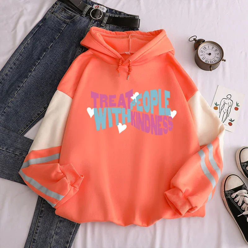 Coral pink hoodie with white sleeves and reflective stripes, blue jeans, vintage clock, and sneakers on white background