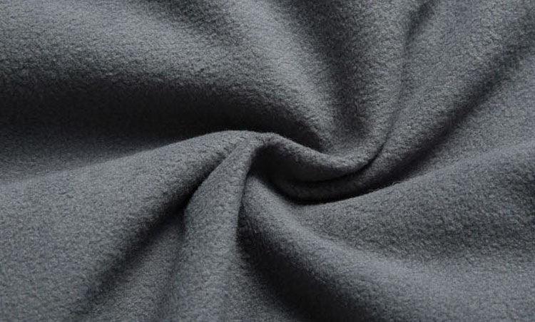Close-up of soft gray fleece fabric with a twisted texture pattern