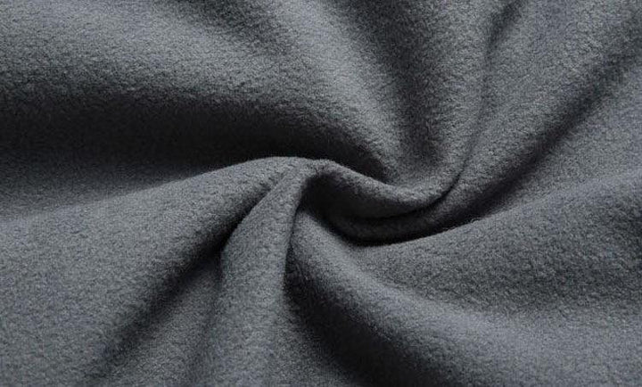 Close-up of soft gray fleece fabric with a twisted texture pattern
