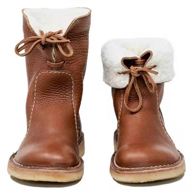 Brown leather winter boots with white shearling lining and laces, front view