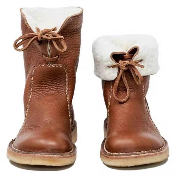 Brown leather winter boots with white shearling lining and laces, front view