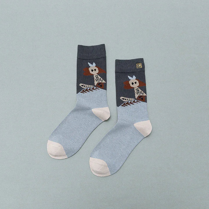 Pair of gray and blue socks with beige toe and heel featuring a brown and beige geometric owl design