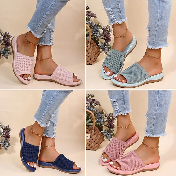 Stylish knitted open-toe slide sandals in pink, gray, navy, and rose, worn with distressed jeans and ankle bracelets