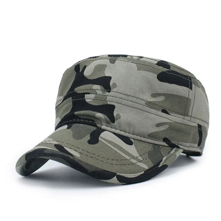 Green and black camouflage military cap with curved brim on white background