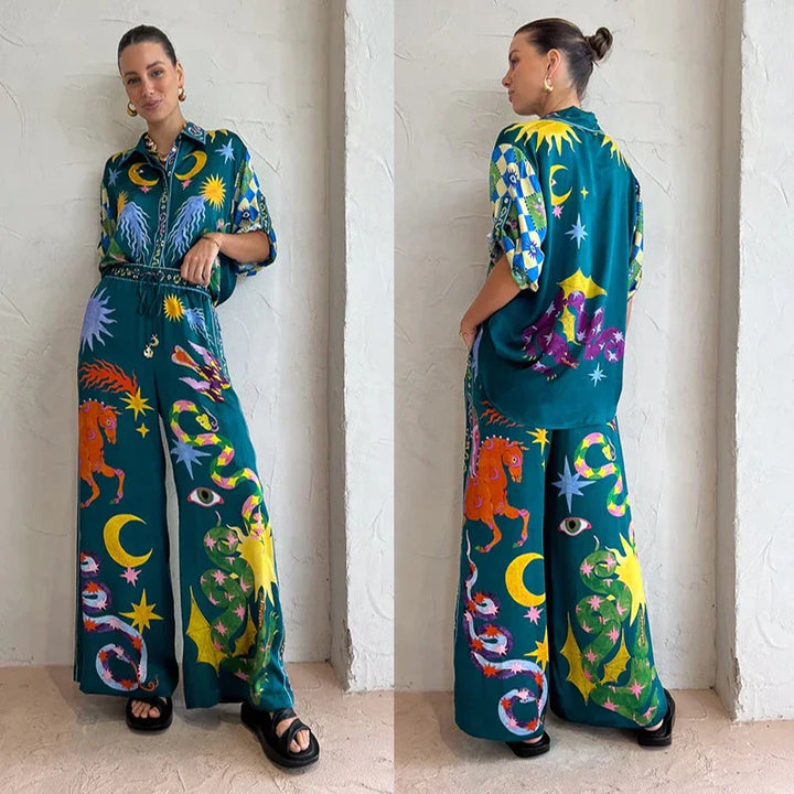 Woman wearing green matching shirt and wide-leg pants with colorful celestial and animal prints