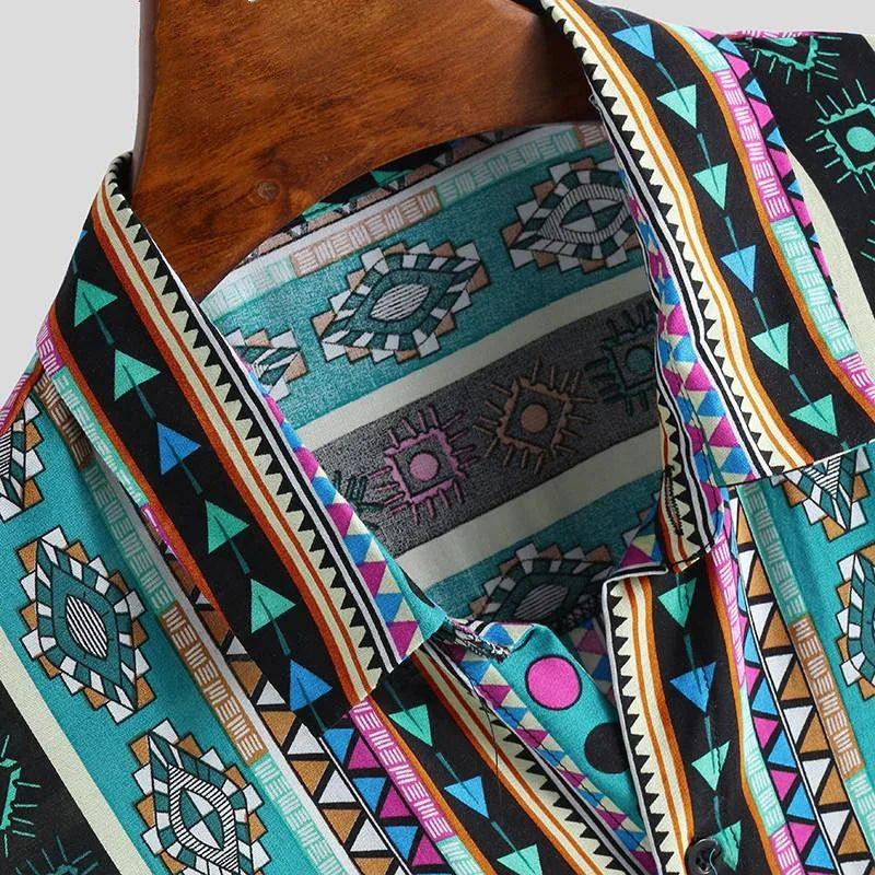 Close-up of vibrant geometric patterned shirt with teal, black, pink, and orange colors on wooden hanger