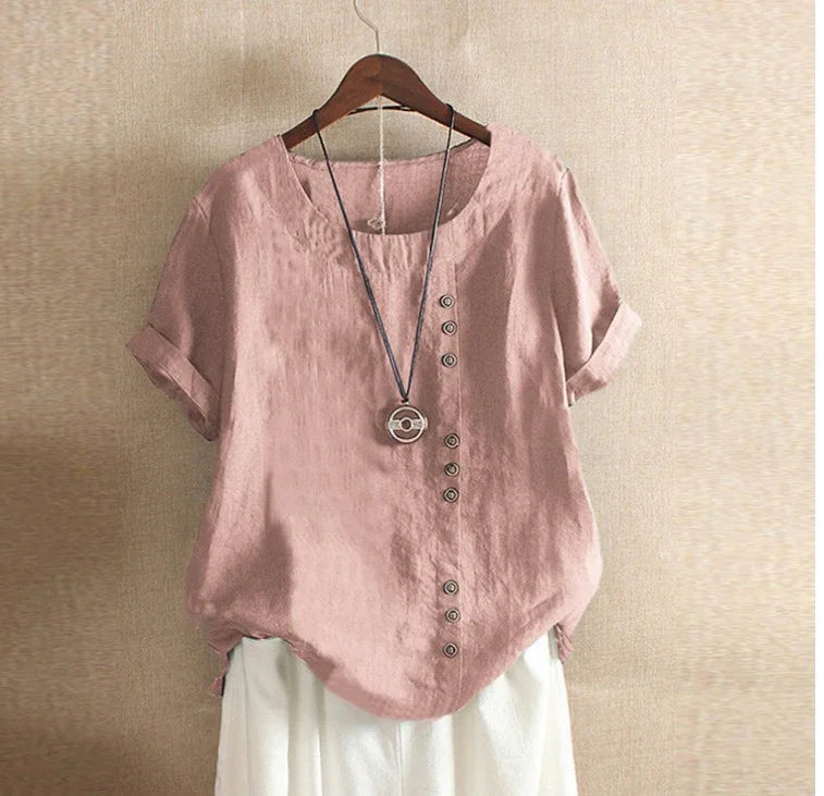 Pink short-sleeve linen top with vertical button details and round neckline on wooden hanger