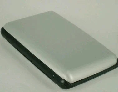 Silver and black external hard drive case on a white surface