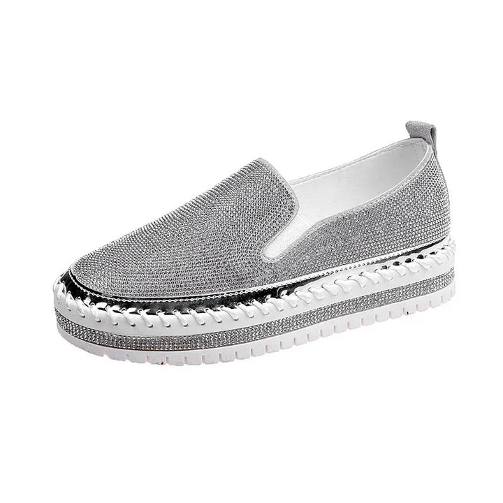 Silver slip-on platform sneaker with rhinestone embellishments and white rubber sole