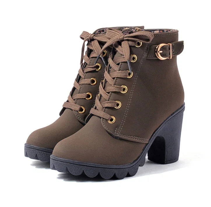 Brown lace-up ankle boots with chunky black heels and gold buckle detail