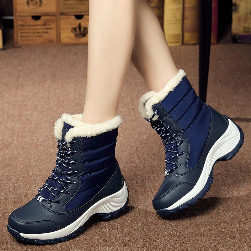 Women's navy blue winter boots with white fur lining and sturdy white soles on carpeted floor