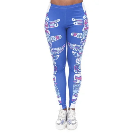 Woman wearing blue leggings with white and pink tribal patterns and silver sneakers