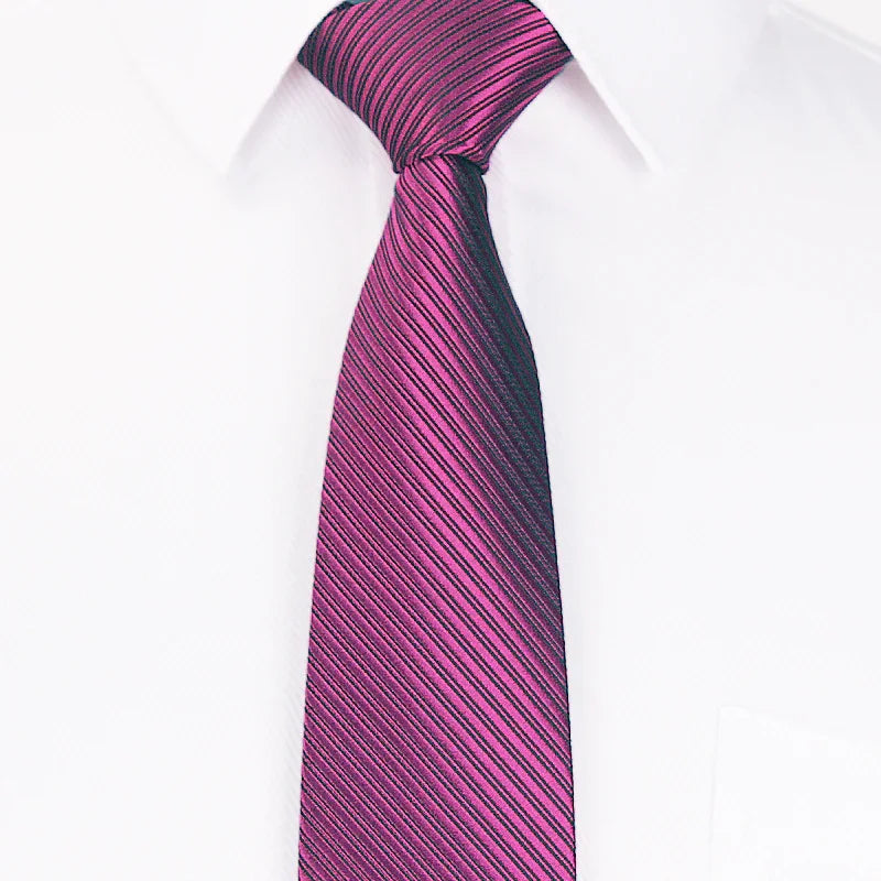 Close-up of a striped purple and black necktie worn with a white dress shirt collar