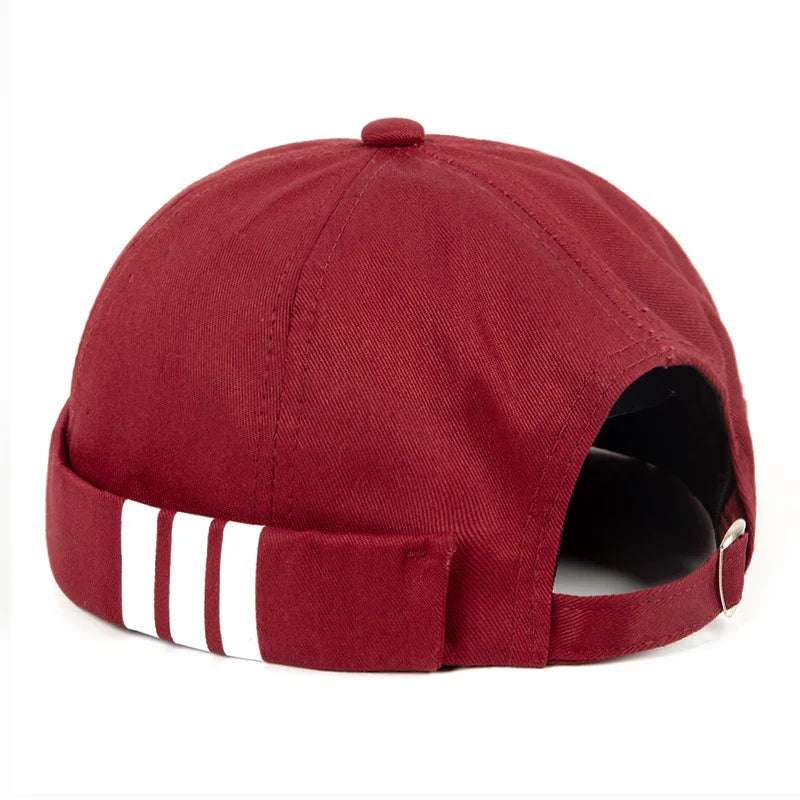 Back view of maroon baseball cap with adjustable strap and three white vertical stripes