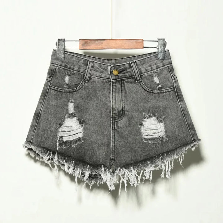 Gray distressed denim shorts with frayed hems hanging on wooden hanger