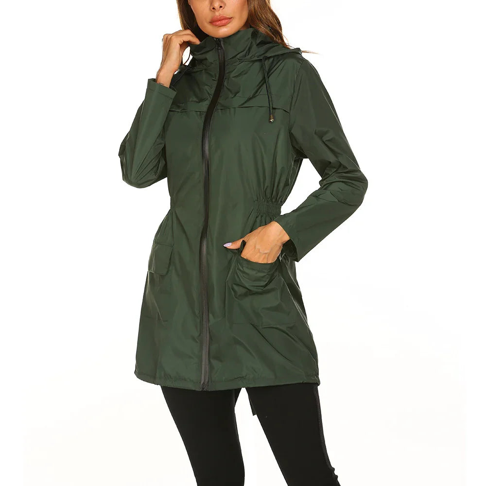 Woman wearing dark green hooded rain jacket with front zipper and pockets