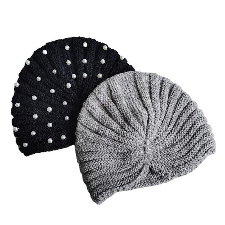 Two knitted beret hats, one black with white pearls and one plain gray, stylish winter accessories