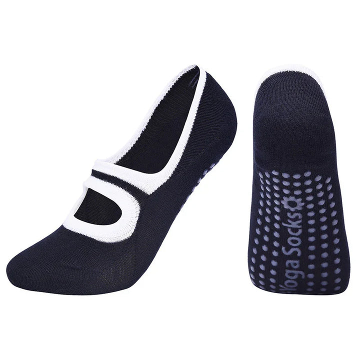 Black yoga socks with white trim and grip dots on sole for non-slip workout