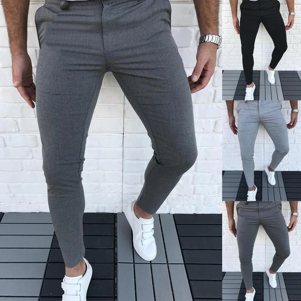Men's slim fit casual pants in gray, black, and light gray worn with white sneakers on outdoor deck