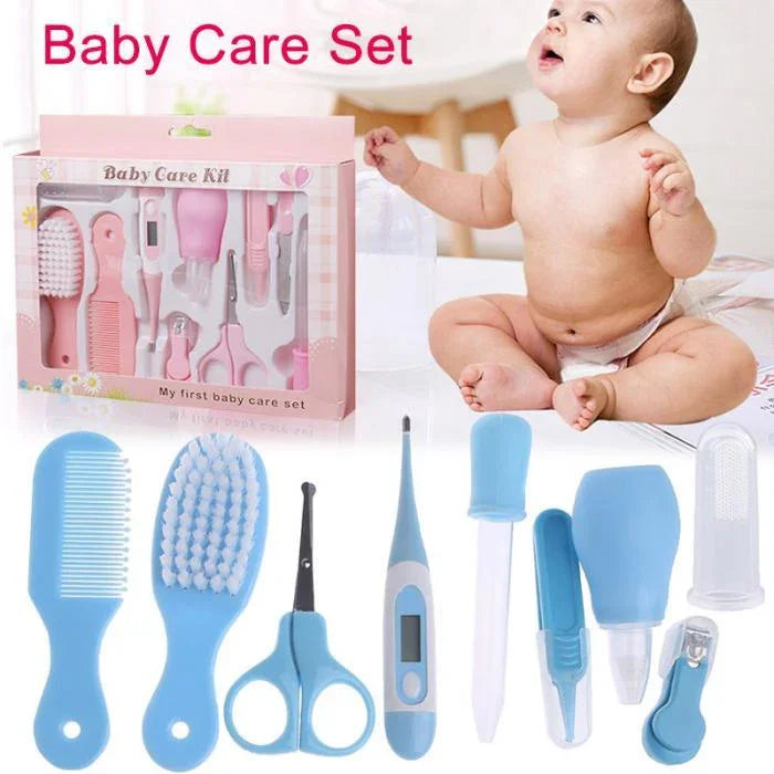 Baby care set with pink grooming kit and blue grooming tools including comb, brush, scissors, thermometer, and nail clippers, baby sitting nearby
