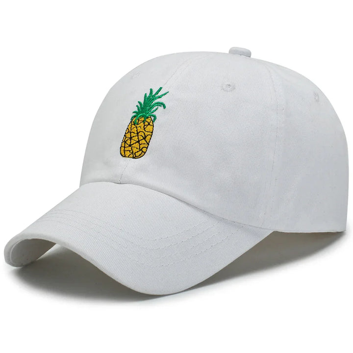 White baseball cap with embroidered yellow pineapple and green leaves design