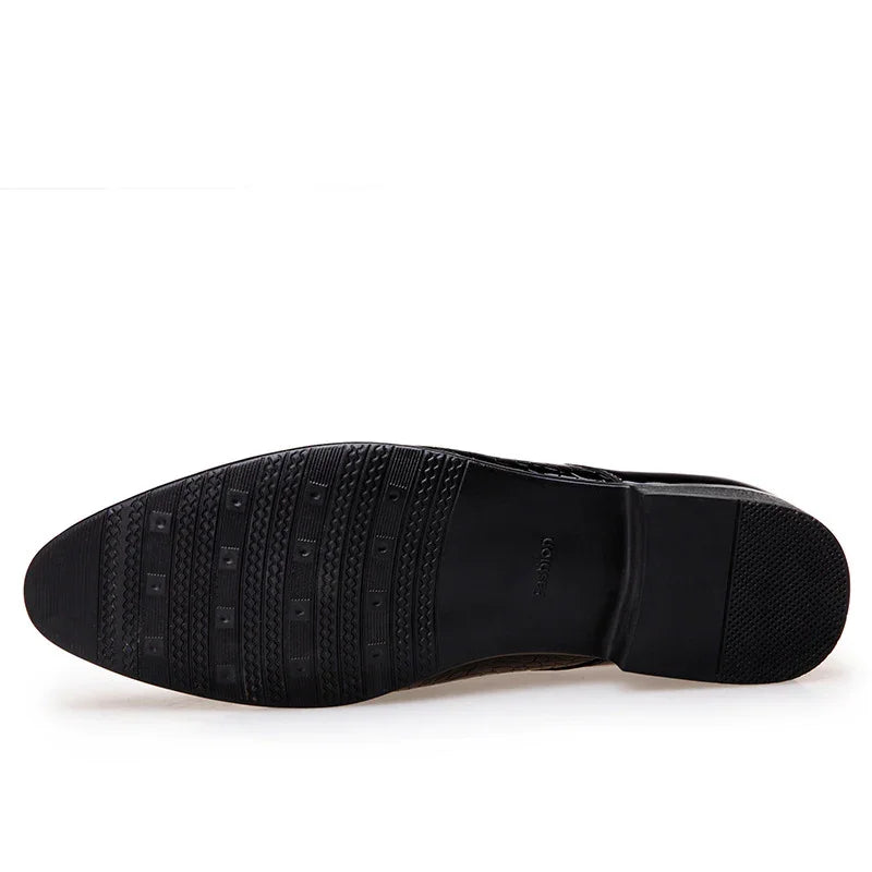 Black rubber sole of men's dress shoe with textured grip and heel detail