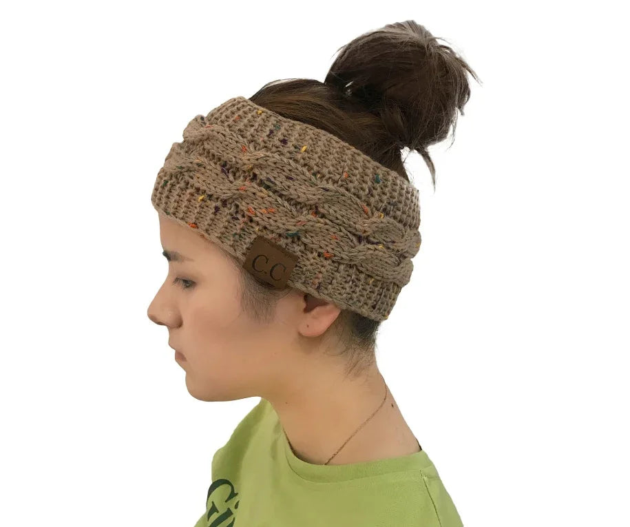 Side profile of woman wearing brown knit headband with CC logo and messy bun hairstyle