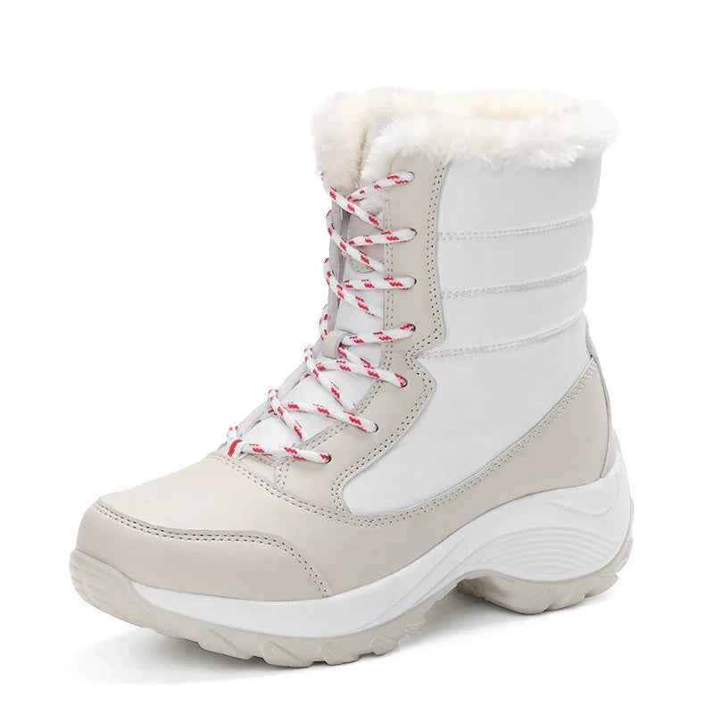 White winter snow boot with beige accents, red and white laces, and faux fur lining