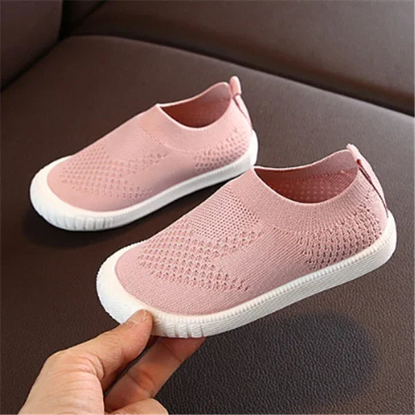 Light pink slip-on knit sneakers with white rubber soles for casual wear
