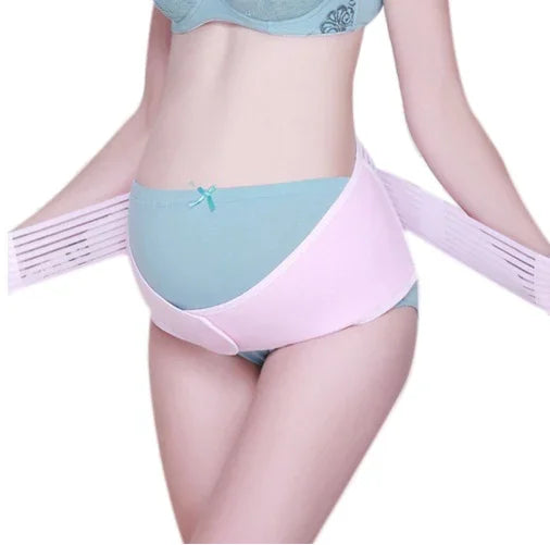 Woman wearing blue maternity underwear and a pink pregnancy support belt around belly