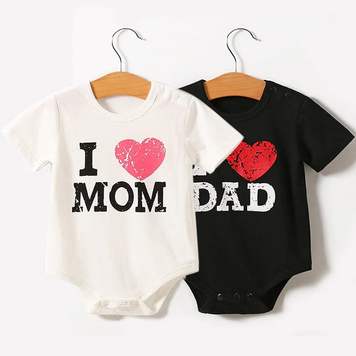 White baby onesie with I love Mom and black baby onesie with I love Dad printed in distressed font