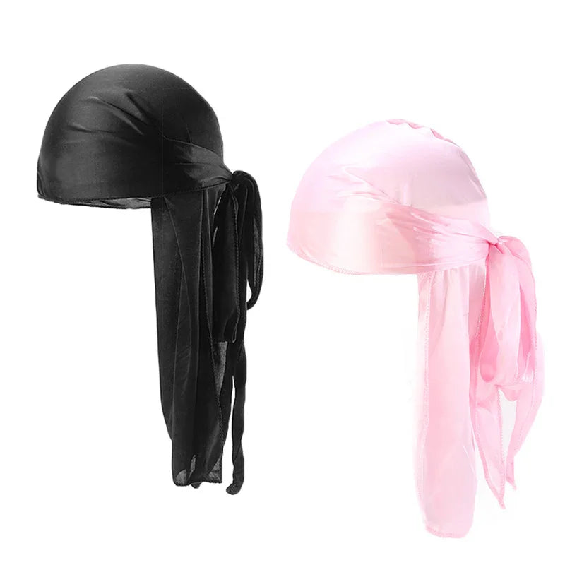 Black and pink satin durags with long ties against white background