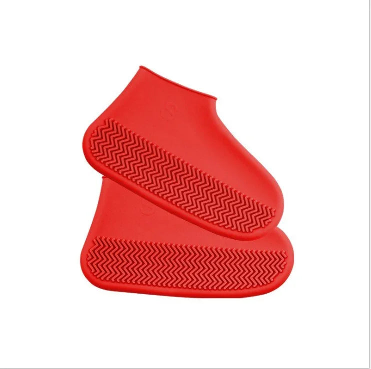 pair of bright red silicone shoe covers with textured anti-slip soles on white background