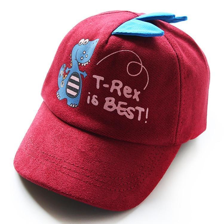 Red kids cap with blue dinosaur design and text 'T-Rex is BEST!' featuring blue fabric spikes