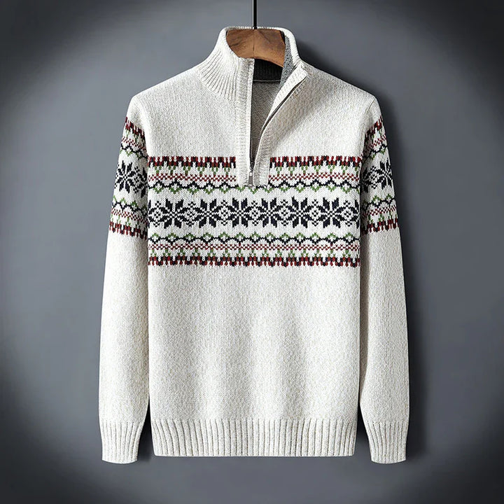 White knit sweater with half zipper and snowflake pattern in black, green, and red on chest and sleeves