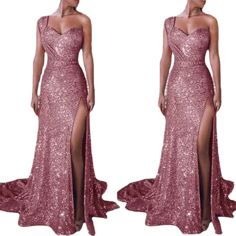 Sparkling rose gold sequin evening gown with one-shoulder strap and high slit on white background