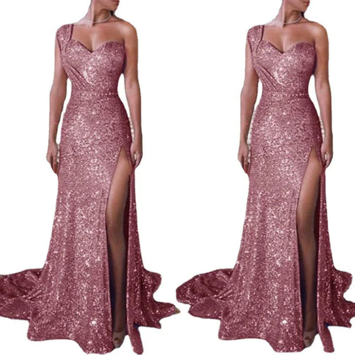 Sparkling rose gold sequin evening gown with one-shoulder strap and high slit on white background