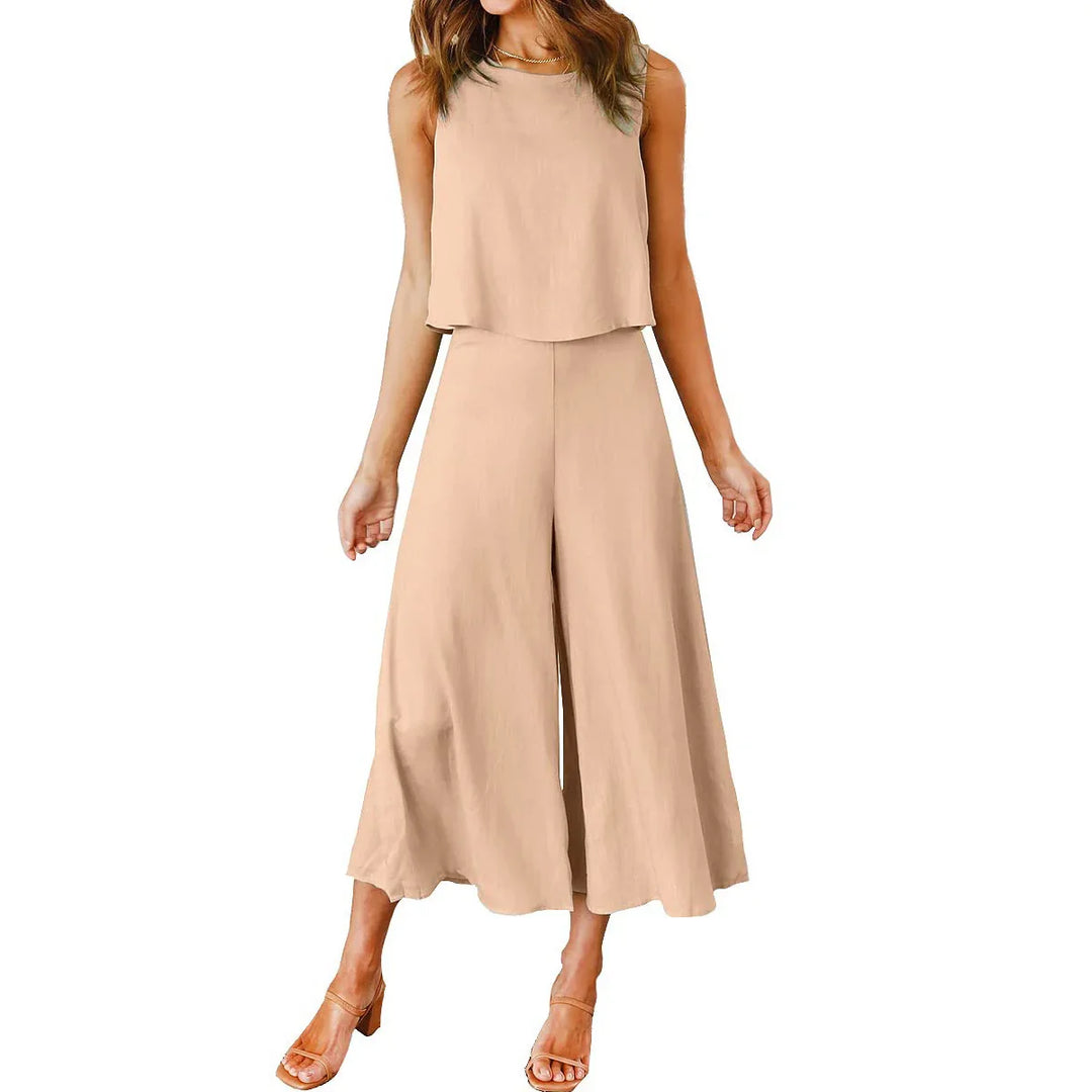 Woman wearing beige sleeveless cropped top and wide-leg pants outfit with nude heels