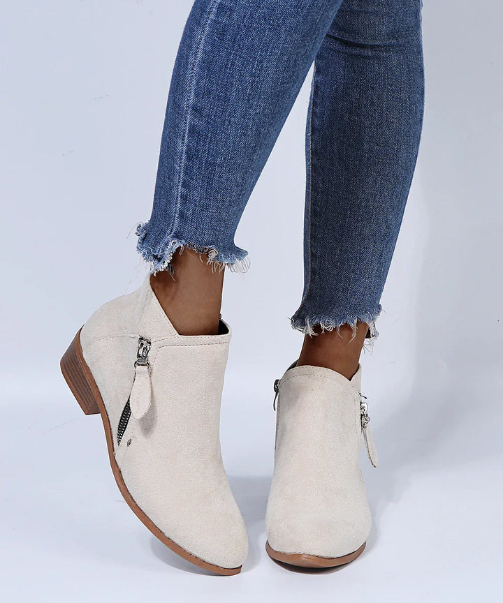women's beige suede ankle boots with side zipper worn with frayed hem blue skinny jeans