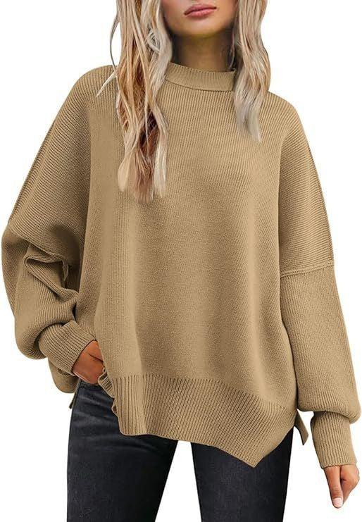 Woman wearing oversized camel beige knit sweater with ribbed cuffs and hem, paired with black jeans