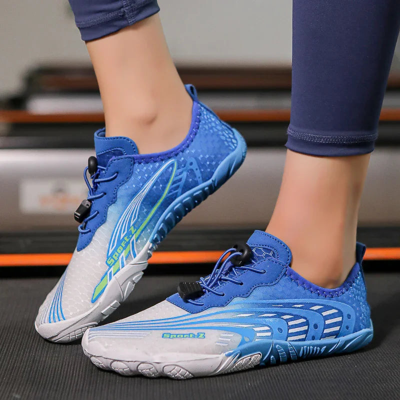 Person wearing blue and white lightweight sports water shoes with elastic laces on black surface